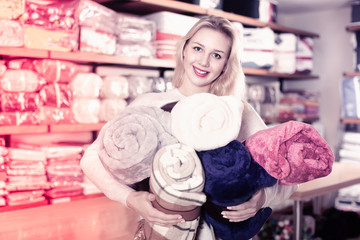 Young female customer boasting purchased home textiles