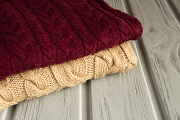 Two pullovers on the grey wooden background