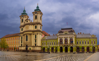 Eger main square in Hungary, Europe with dark moody sky and catholic cathedral. Travel outdoor european background