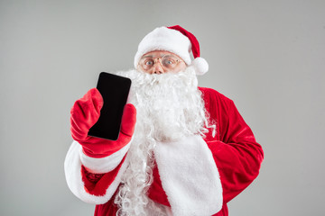 Santa Claus showing a cell phone