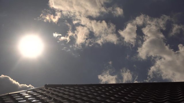 Modern roof covered with tile effect PVC coated brown metal roof sheets and blue sky