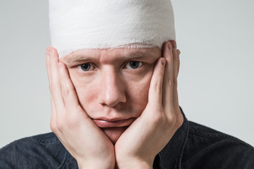 Man with bandage on his head