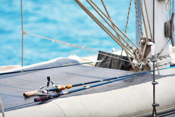 Fishing rods on a yacht board. Sea fishing in clear sunny weather. 