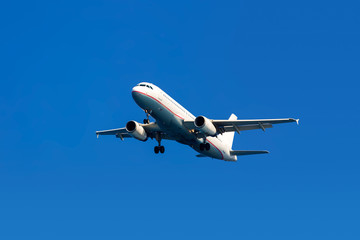 Fototapeta na wymiar Airplane on a blue sky background