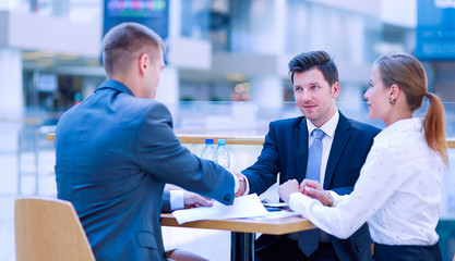 Group of happy young business people in a meeting at office