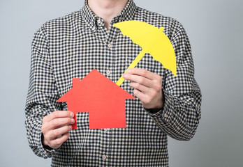 Man holding red house model