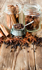 Obraz na płótnie Canvas Clove, cinnamon in sticks, anise illicium on old wooden table in rustic style