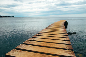 Fototapeta premium Old wooden Bridge In The Sea