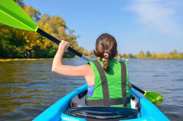Family kayaking, child paddling in kayak on river canoe tour, kid on active summer weekend and...