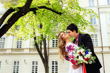 Man kissing his wife in the neck softly. Feeling happy