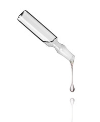 Cosmetic or medical ampoule with falling drop down on white background