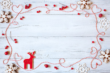 Christmas wooden background with snowflakes, cookies and twine in the form of heart - obrazy, fototapety, plakaty