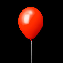 Red air balloon on white ribbon isolated on black