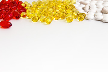 Pills background. Heap of medicine tablets and pills different colors on white background. Healthcare or medicament addiction concept. Copy space.