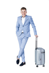 young man in blue suit  with suitcase 