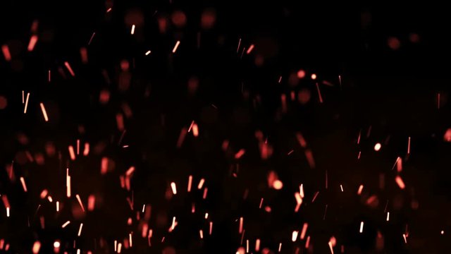 Beautiful fire sparks in the night, dark background. Loop animation.