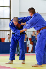 Obraz premium Judoka in blue judogi holding his dominant guard