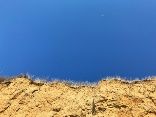 Sandy-clay mountains on the sea shore.
