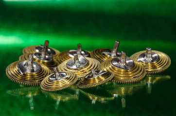 Watch Repair: Vintage Pocket Watch Fusee Cones Resting on a Green Surface