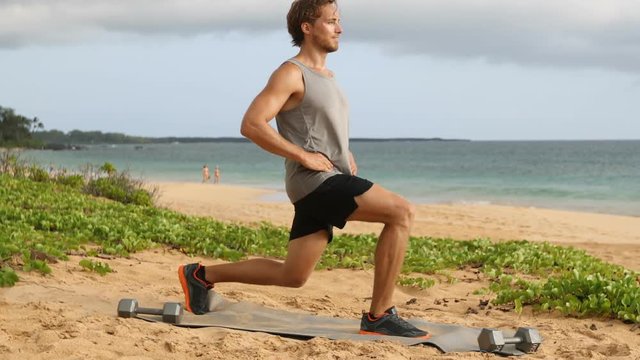 Lunges exercise - fitness man doing lunge workout exercising legs. Male fitness model doing Alternating Bodyweight Lunge workout training glutes, hamstrings and quadriceps.