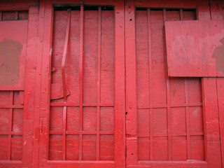 closeup of a red painted wooden door and window