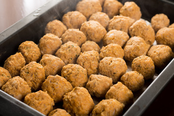 Homemade raw minced meat meatballs on the baking tray