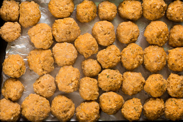 Flat lay above minced meat meatballs in the baking tray