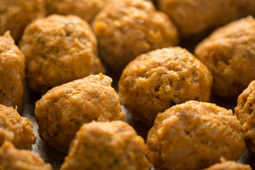 Homemade raw minced meat meatballs on the baking tray