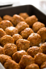 Homemade raw minced meat meatballs on the baking tray