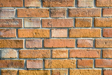 Background wall is solid red brick. The structure of bricks. Orange textured fence. Architectural...
