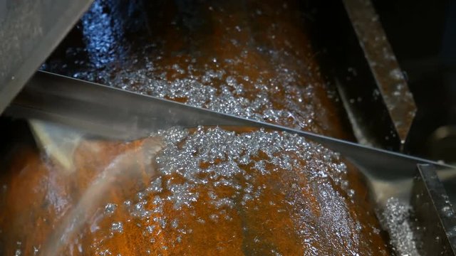 Industrial metal machining cutting process of blank detail by electrical saw. Close up