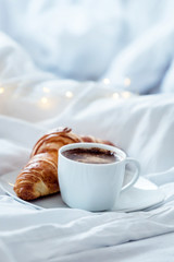 cup coffee with croissant