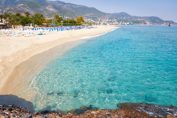 Tropical resort sea beach on summer vacation. Beach with white sand, Alanya Turkey. - obrazy, fototapety, plakaty