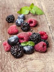 Ripe and sweet berries on wooden background