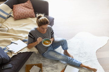 Beautiful woman eating soup.