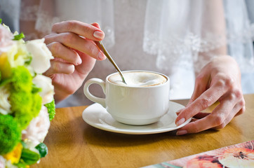 Beautiful bride drinking coffee