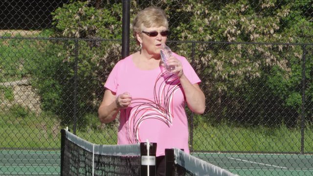 Elderly woman at the tennis court