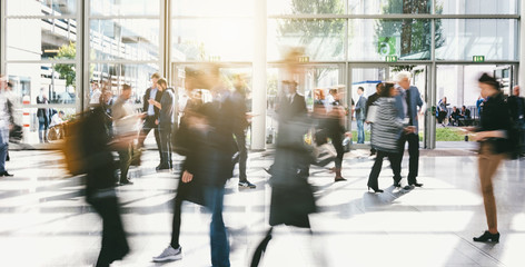 Crowd of anonymous business people walking in a corridor