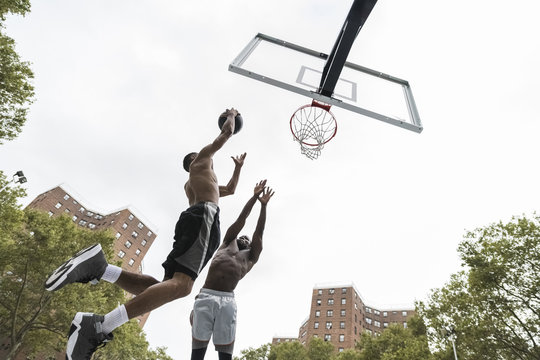 Low angle view of two men playing basketball