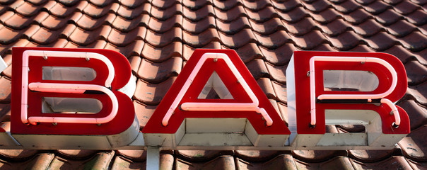 Red neon BAR sign