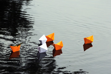 Paper boats in still water