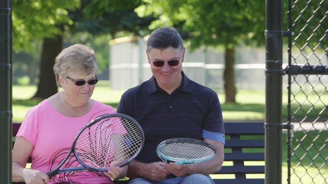 Portrait of elderly couple at the tennis court