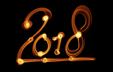 Happy new year 2018 isolated numbers lettering written with fire flame or smoke on black background