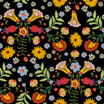 Embroidery ethnic seamless pattern with colorful flowers. Vector traditional floral bouquet. Tribal style design for fashion wearing.