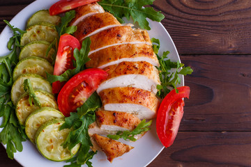 Healthy food, diet concept. Baked chicken breasts with zucchini and salad, copy space
