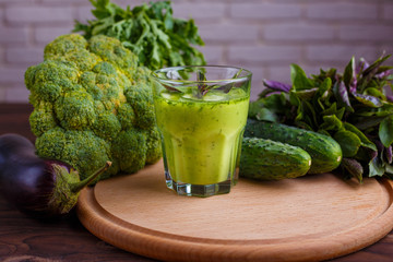 Diet concept, healthy lifestyle, low calorie detox and dietary food. Blended green smoothie with ingredients on wooden table