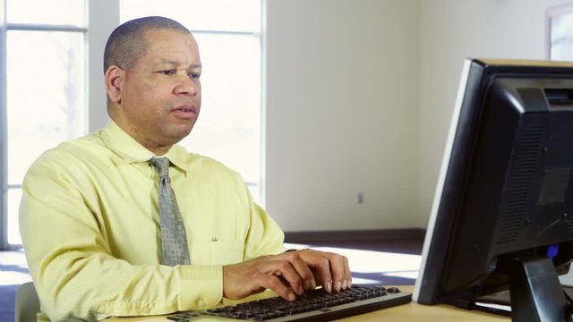 Business man typing on computer