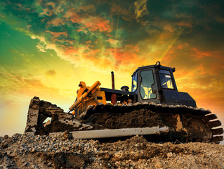 bulldozer on a building site at sunset © ABCDstock