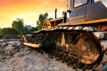 bulldozer on a building site at sunset © ABCDstock