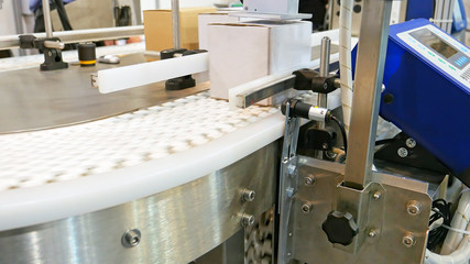 Food factory automated robotic machine. Conveyor product line for cooking and packing rations and food packs. Robotics and automatic lines used instead of human labor on factories and plants.